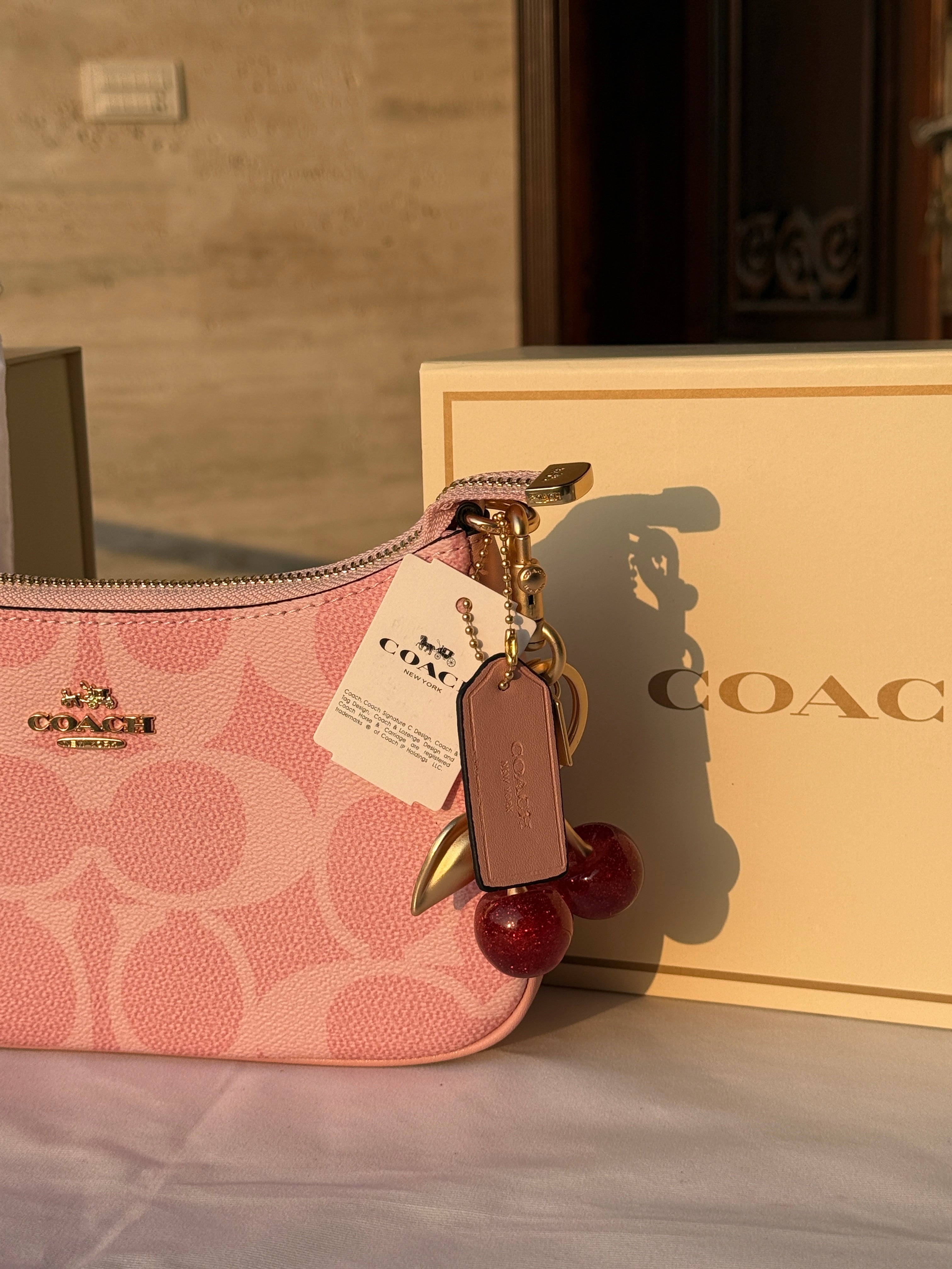 COACH PINK BAG WITH CHERRY CHARM AND 2 STRIPS
