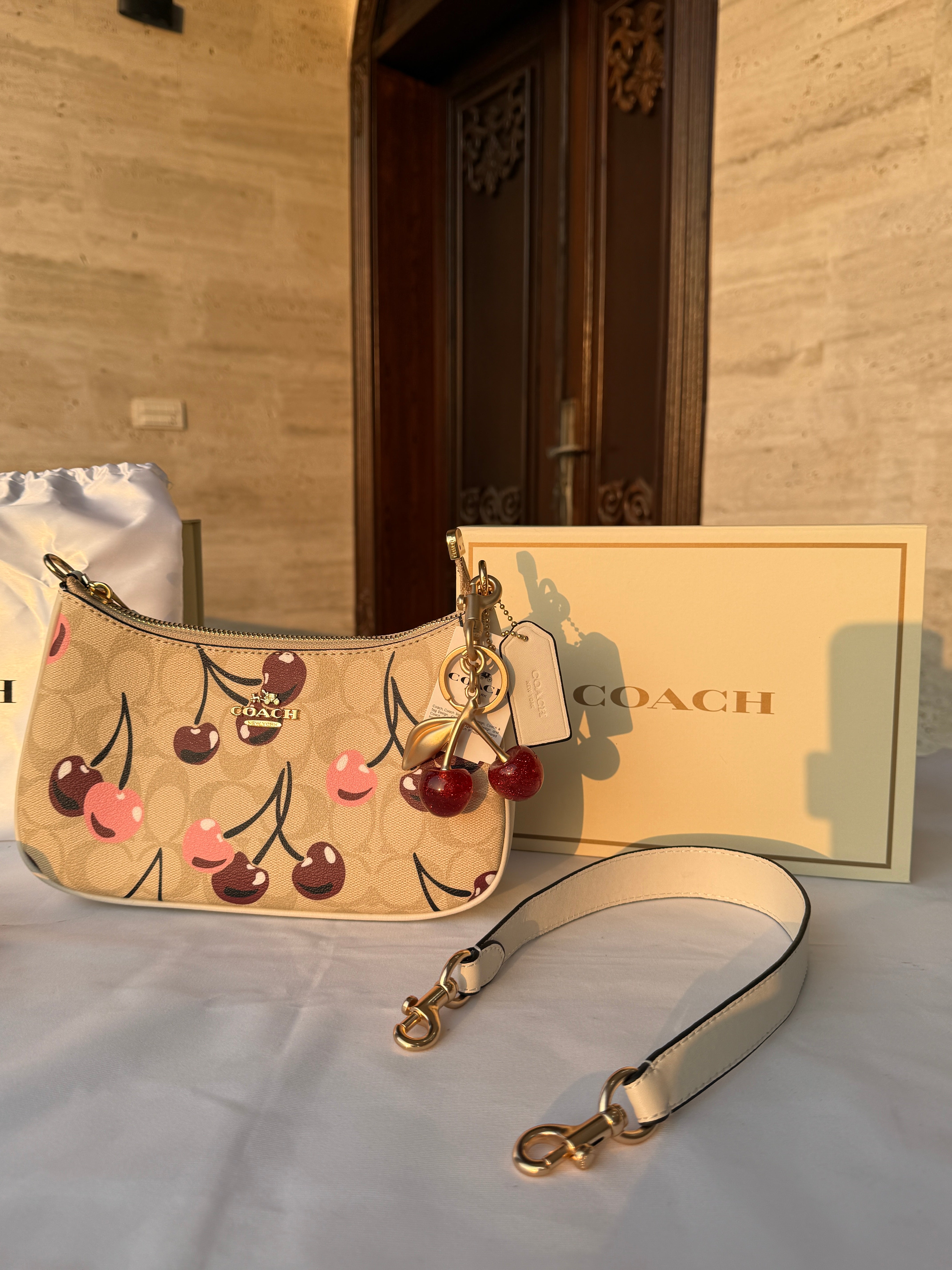 COACH BEIGE CHERRY PATTERN BAG WITH CHERRY CHARM AND 2 STRIPS