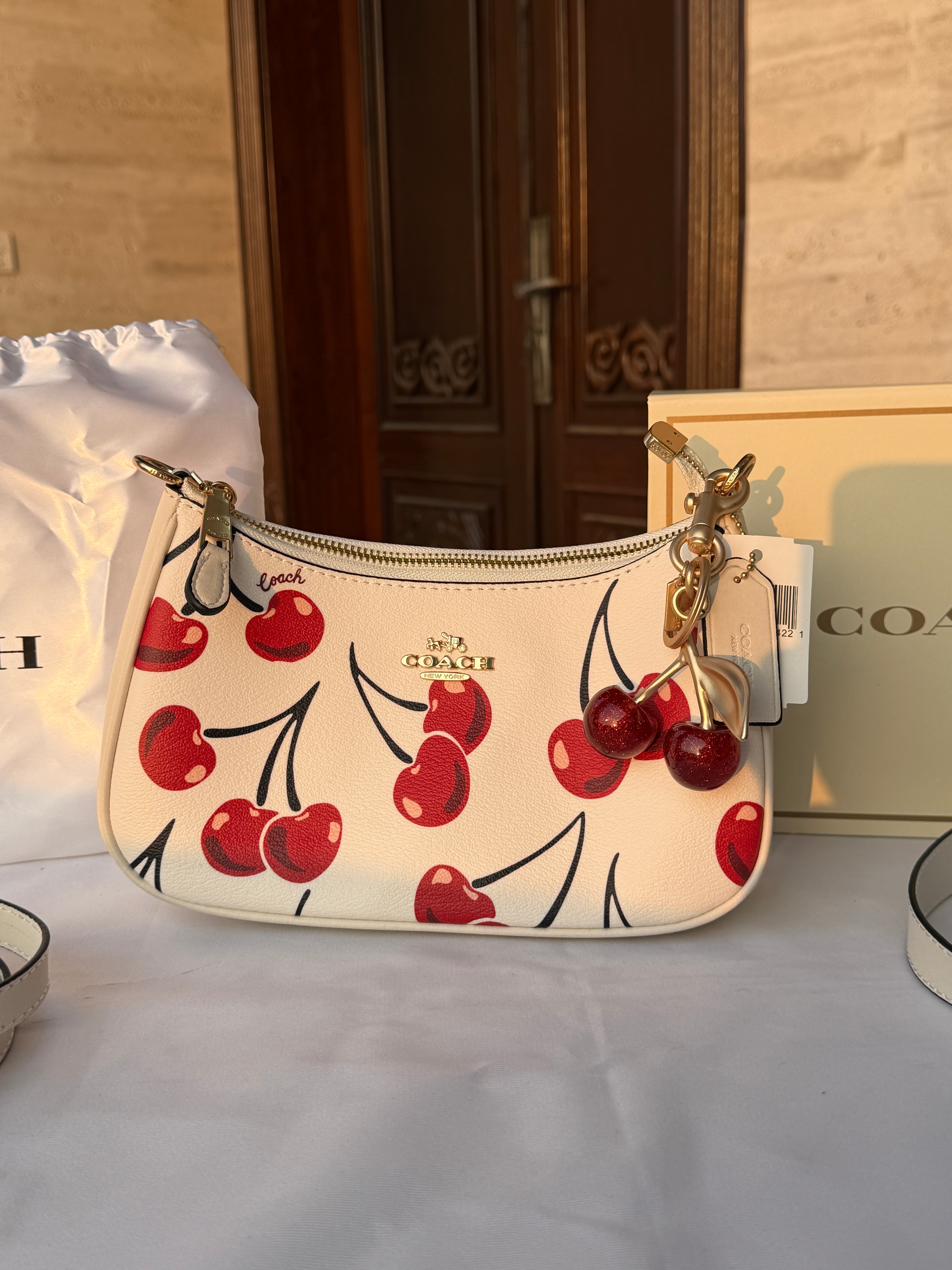 COACH WHITE CHERRY PATTERN BAG WITH CHERRY CHARM AND 2 STRIPS