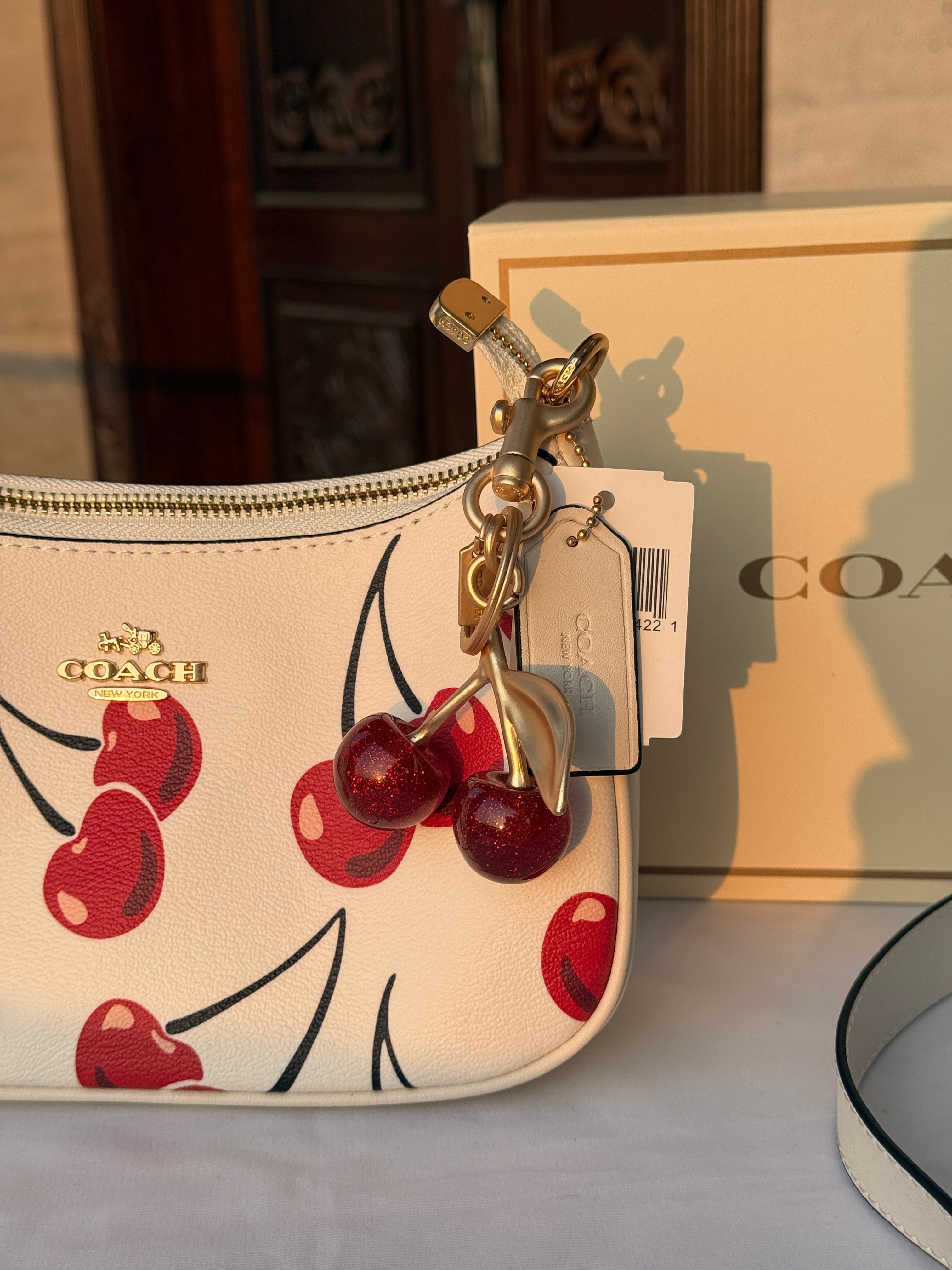 COACH WHITE CHERRY PATTERN BAG WITH CHERRY CHARM AND 2 STRIPS