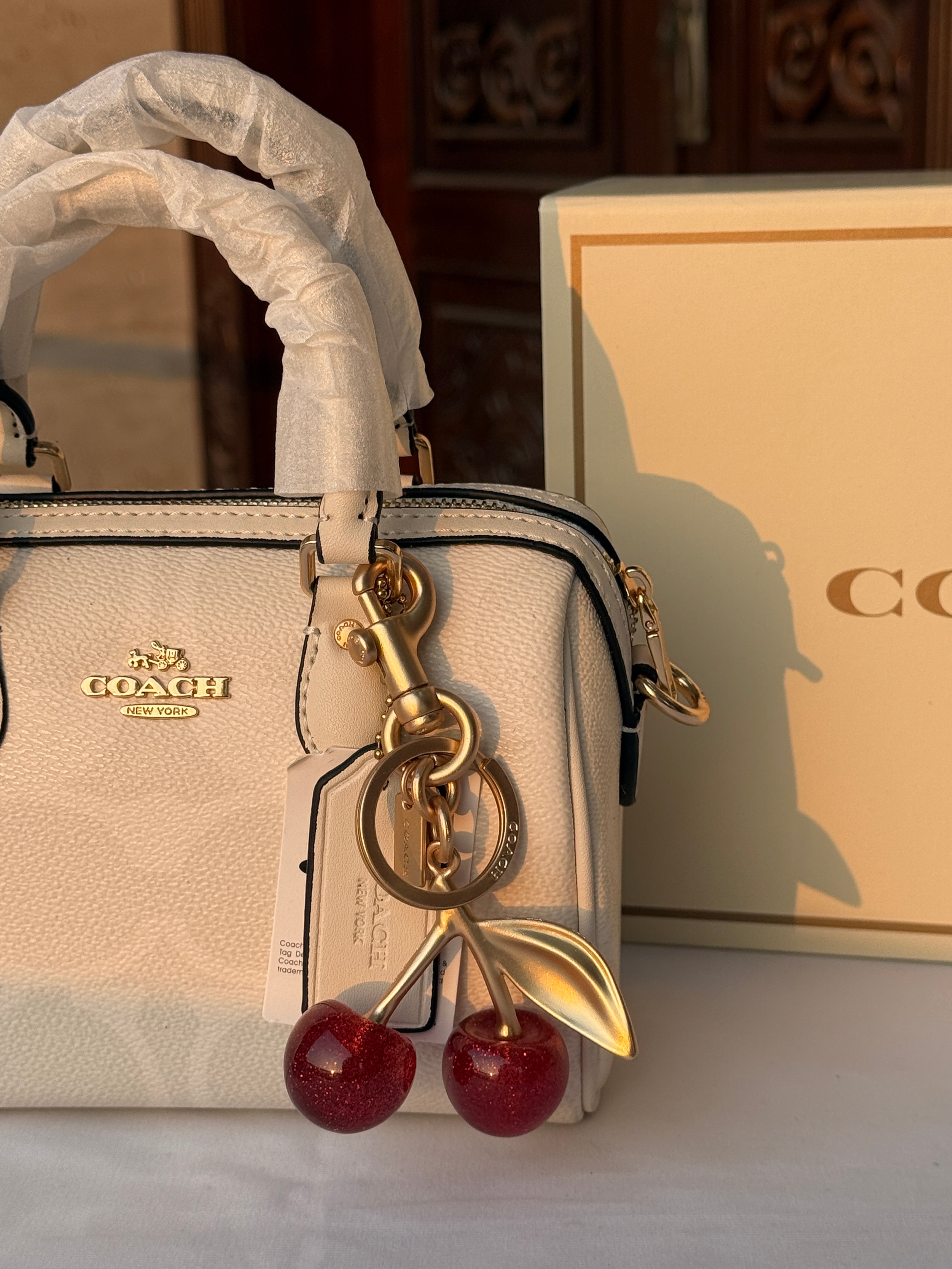 COACH WHITE PATTERN BAG WITH CHERRY CHARM
