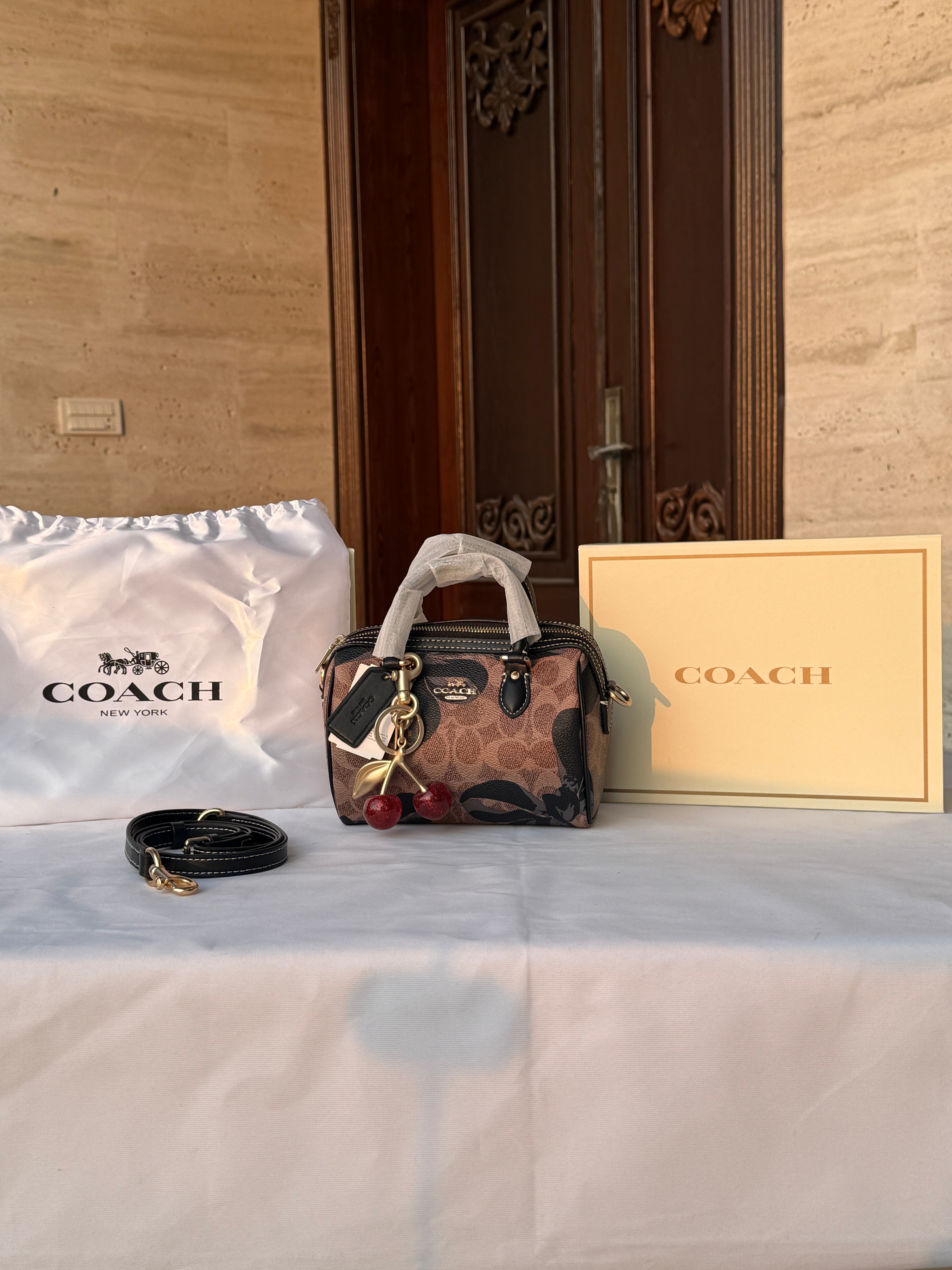 COACH BROWN WITH BLACK PATTERN BAG AND CUTE CHERRY CHARM
