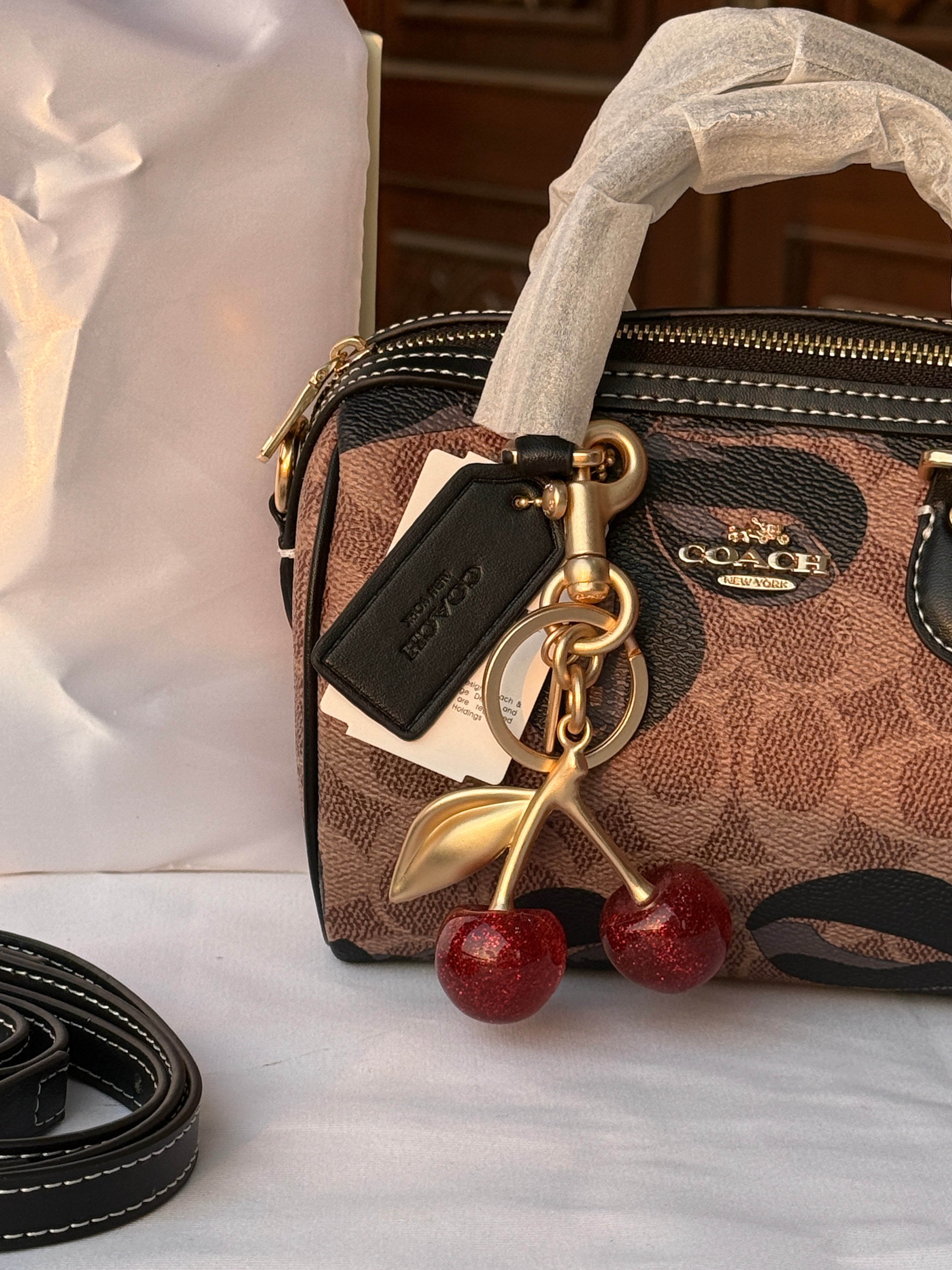 COACH BROWN WITH BLACK PATTERN BAG AND CUTE CHERRY CHARM