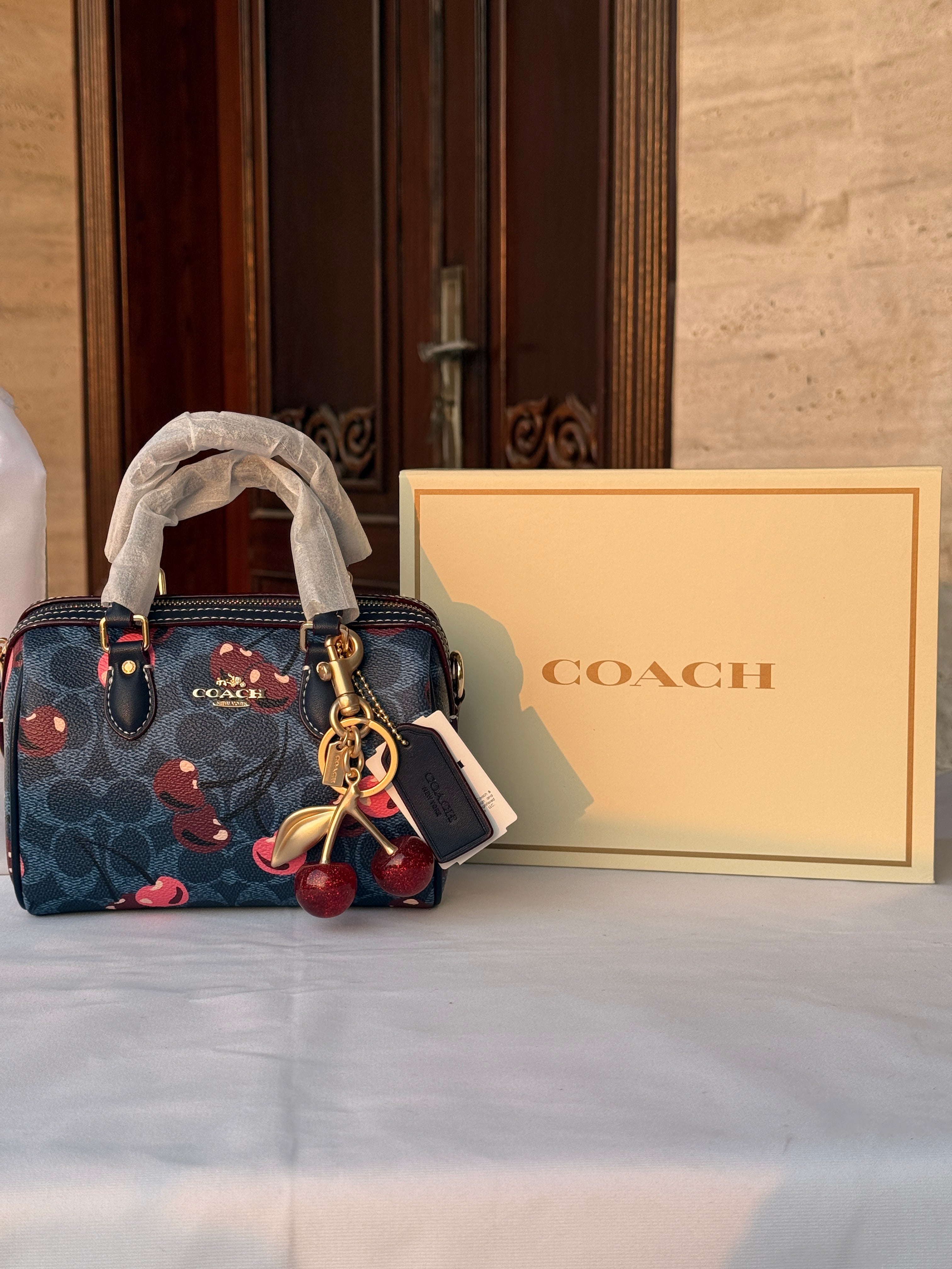 COACH BLUE BAG WITH CHERRY PATTERN AND CHERRY CHARM