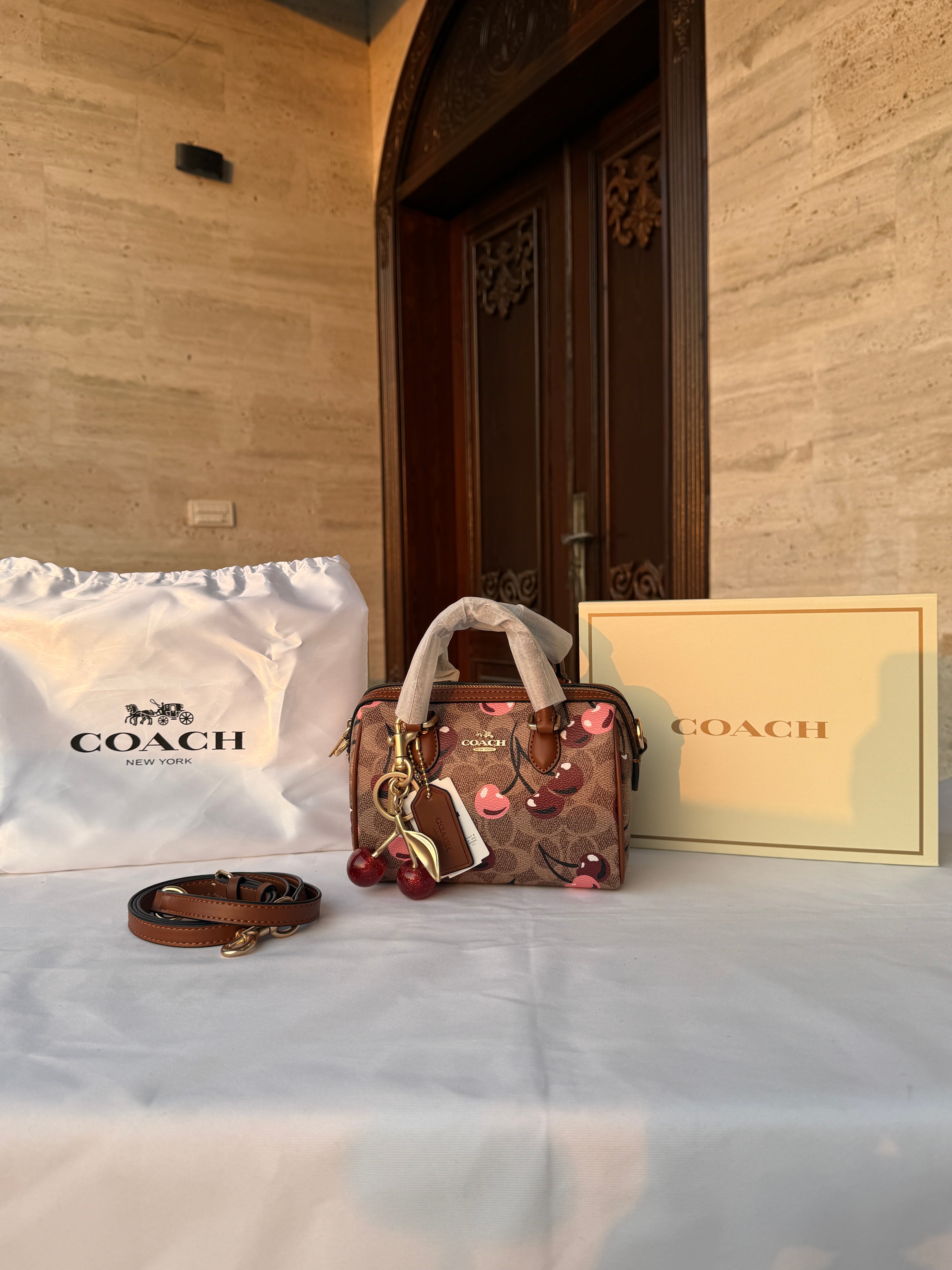 COACH LIGHT BROWN /TAN BASE CHERRY PATTERN BAG WITH CHERRY CHARM