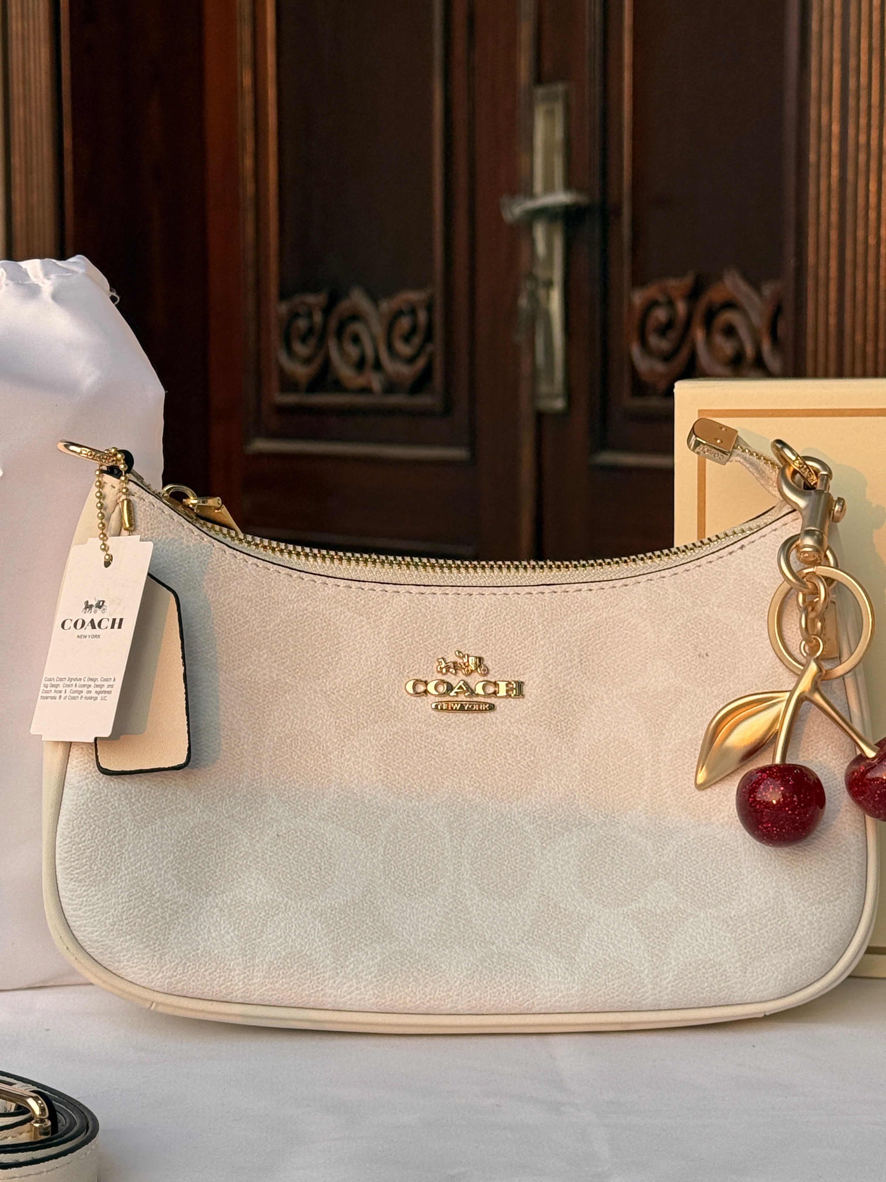 COACH WHITE PATTERN BAG WITH CHERRY CHARM AND 2 STRIPS