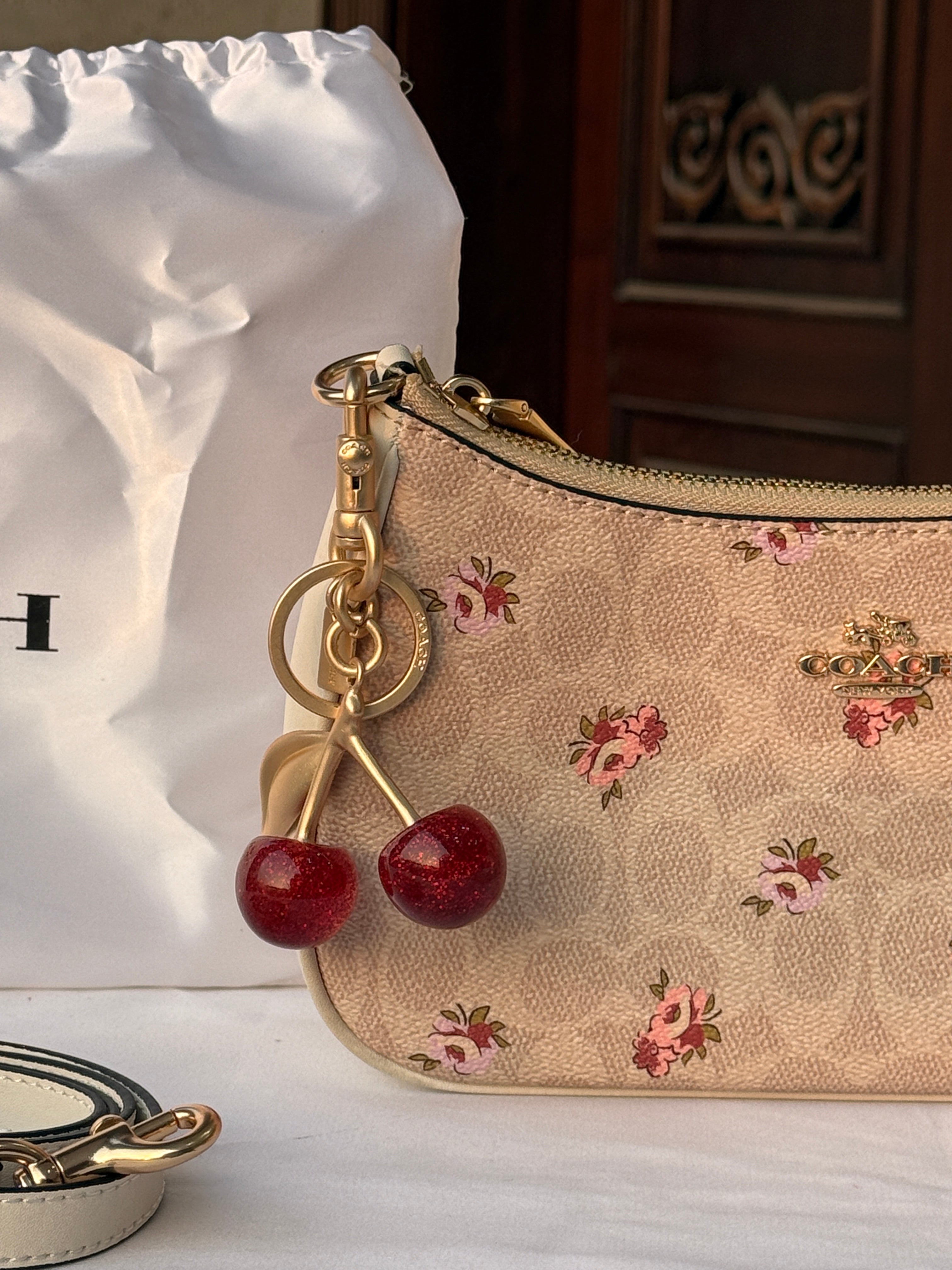 COACH LIGHT BROWN FLOWER PATTERN BAG WITH CHERRY CHARM AND 2 STRIPS